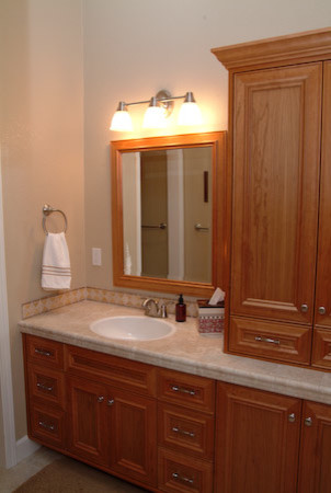 Medium sized classic ensuite bathroom in Sacramento with a built-in sink, medium wood cabinets, tiled worktops, a one-piece toilet, ceramic tiles, yellow walls and porcelain flooring.
