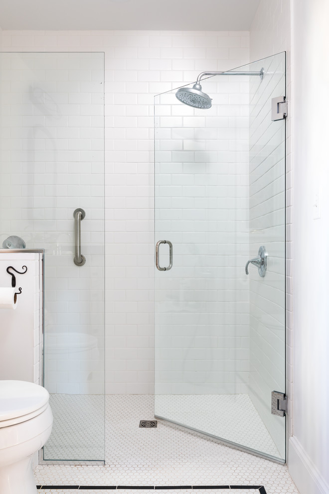 Medium sized classic ensuite bathroom in Boston with flat-panel cabinets, medium wood cabinets, an alcove shower, a one-piece toilet, white tiles, ceramic tiles, white walls, porcelain flooring, a submerged sink, soapstone worktops, white floors, a hinged door and black worktops.