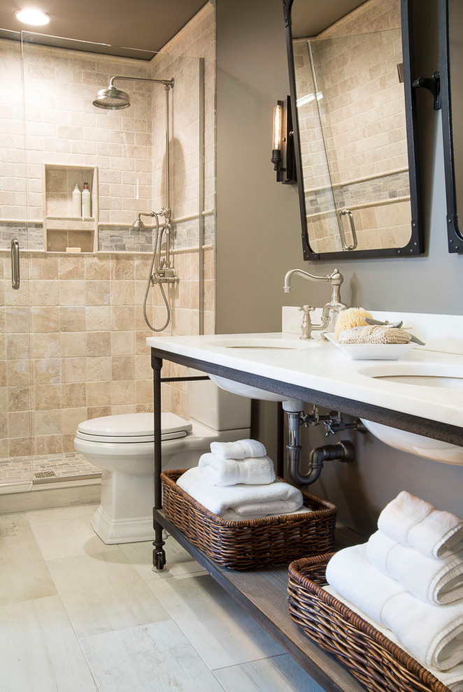 Photo of a medium sized traditional family bathroom in St Louis with open cabinets, distressed cabinets, a walk-in shower, a two-piece toilet, beige tiles, stone tiles, grey walls, limestone flooring, a submerged sink and marble worktops.