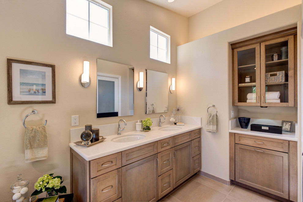 Inspiration for a mid-sized timeless master white tile and porcelain tile beige floor and porcelain tile bathroom remodel in San Francisco with recessed-panel cabinets, a one-piece toilet, white walls, an undermount sink, quartz countertops, a hinged shower door and medium tone wood cabinets