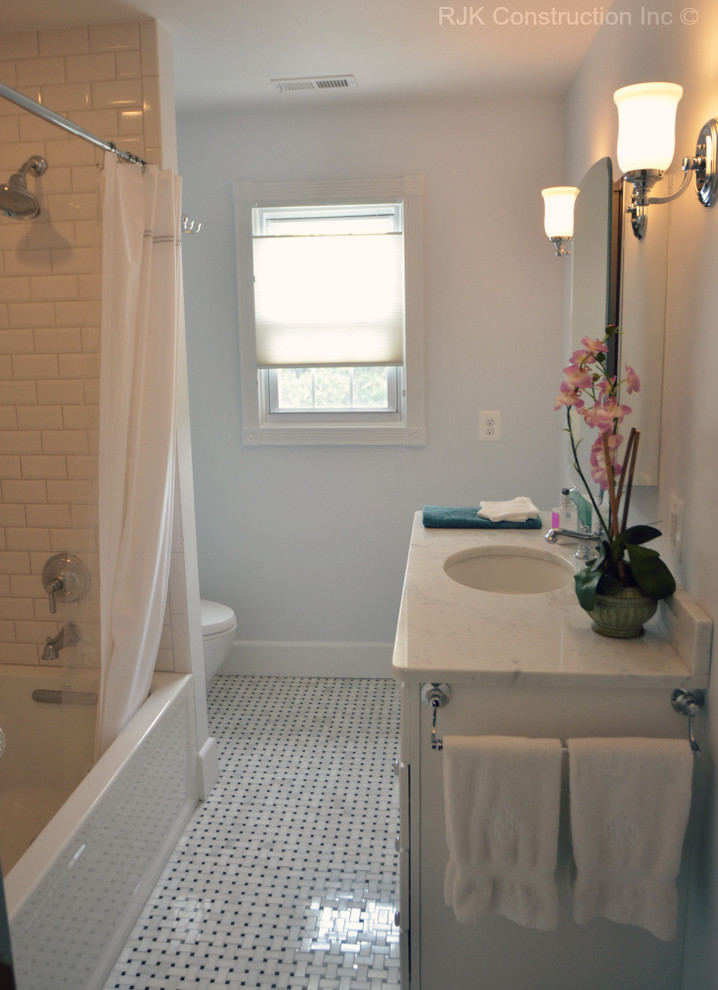 Design ideas for a traditional bathroom in DC Metro with a shower/bath combination and white tiles.