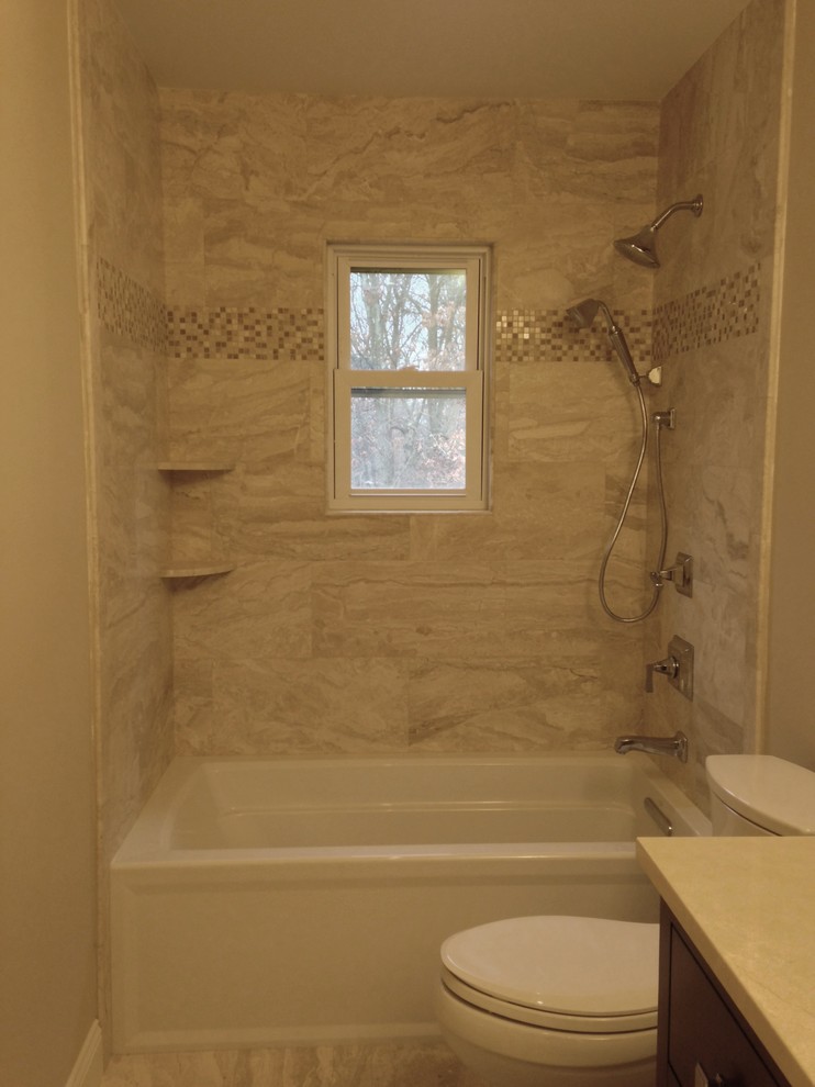 Photo of a classic bathroom in Other with a submerged sink, freestanding cabinets, dark wood cabinets, granite worktops, an alcove bath, a shower/bath combination, beige tiles, stone tiles, beige walls and marble flooring.