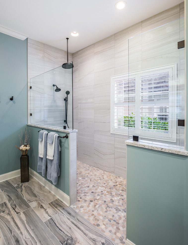 Photo of a nautical bathroom in Jacksonville with recessed-panel cabinets, blue cabinets, a walk-in shower, a two-piece toilet, green tiles, porcelain tiles, blue walls, porcelain flooring, a submerged sink, engineered stone worktops, blue floors, an open shower and multi-coloured worktops.