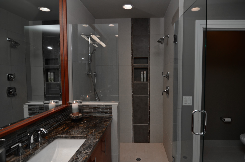 Example of a mid-sized trendy master gray tile and porcelain tile porcelain tile alcove shower design in Portland with an undermount sink, flat-panel cabinets, medium tone wood cabinets, granite countertops, an undermount tub and gray walls