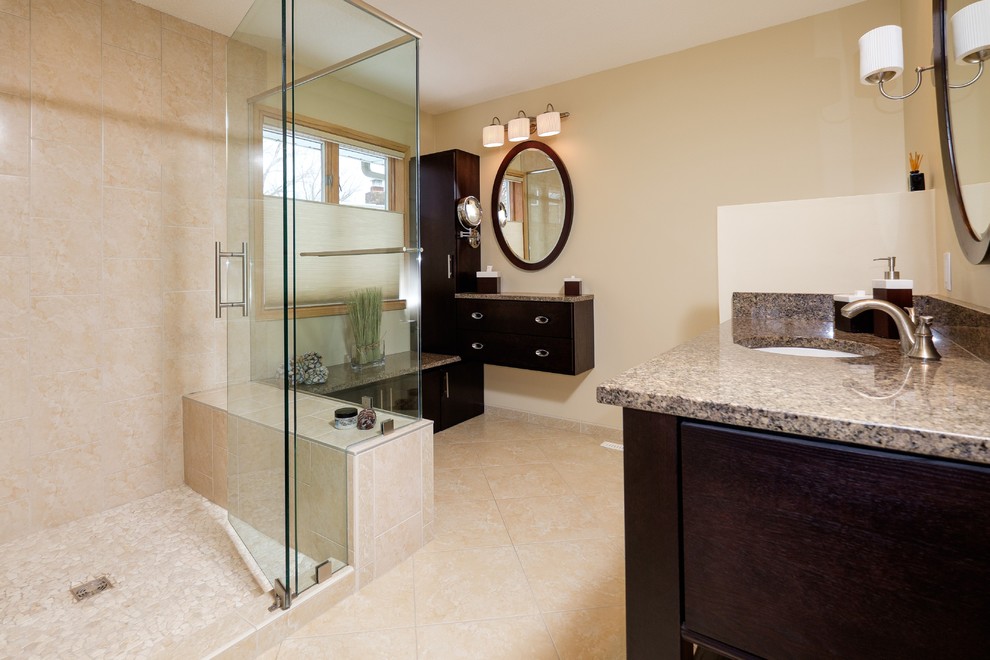 Corner shower - mid-sized transitional master beige tile and porcelain tile porcelain tile corner shower idea in Minneapolis with an undermount sink, flat-panel cabinets, dark wood cabinets, granite countertops, a one-piece toilet and yellow walls