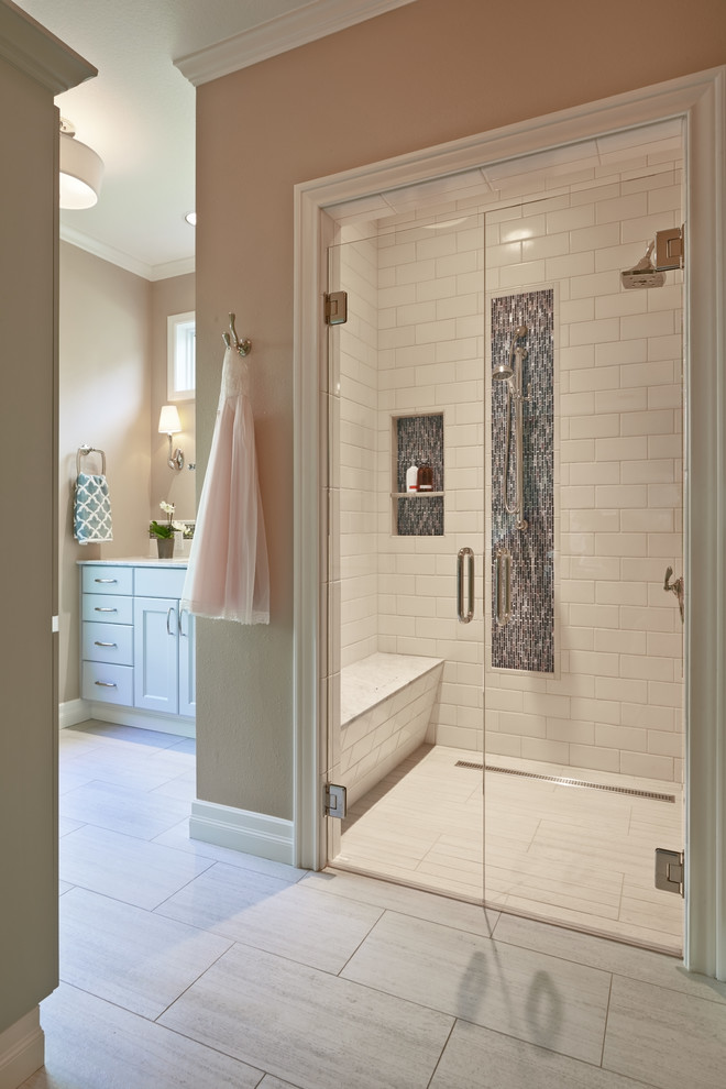 Example of a large transitional master multicolored tile and glass sheet porcelain tile walk-in shower design in Portland with recessed-panel cabinets, blue cabinets, a two-piece toilet, brown walls, an undermount sink and marble countertops