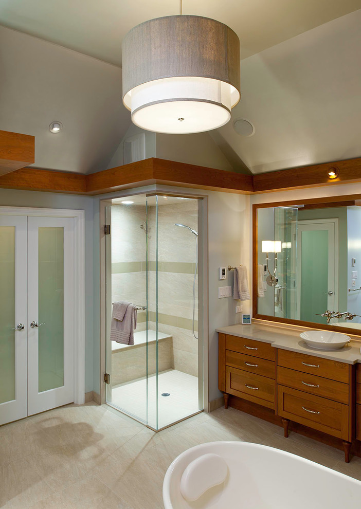 Traditional ensuite bathroom in Other with a vessel sink, medium wood cabinets, beige tiles, grey walls, a double shower, a freestanding bath, porcelain tiles, porcelain flooring and flat-panel cabinets.