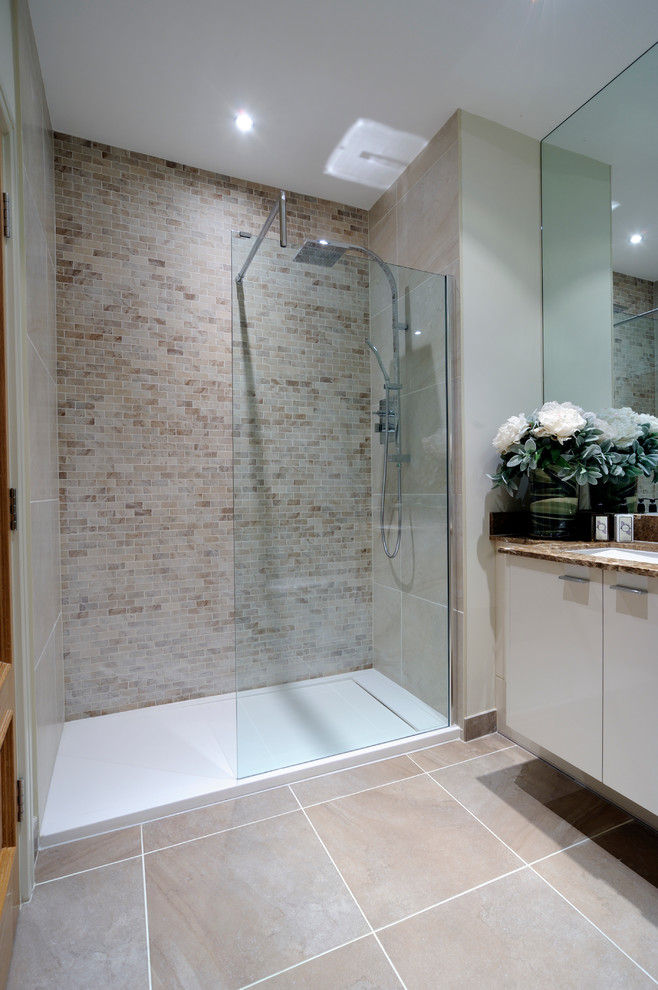 На фото: ванная комната в стиле неоклассика (современная классика) с врезной раковиной, плоскими фасадами, душем в нише, бежевой плиткой и плиткой кабанчик с