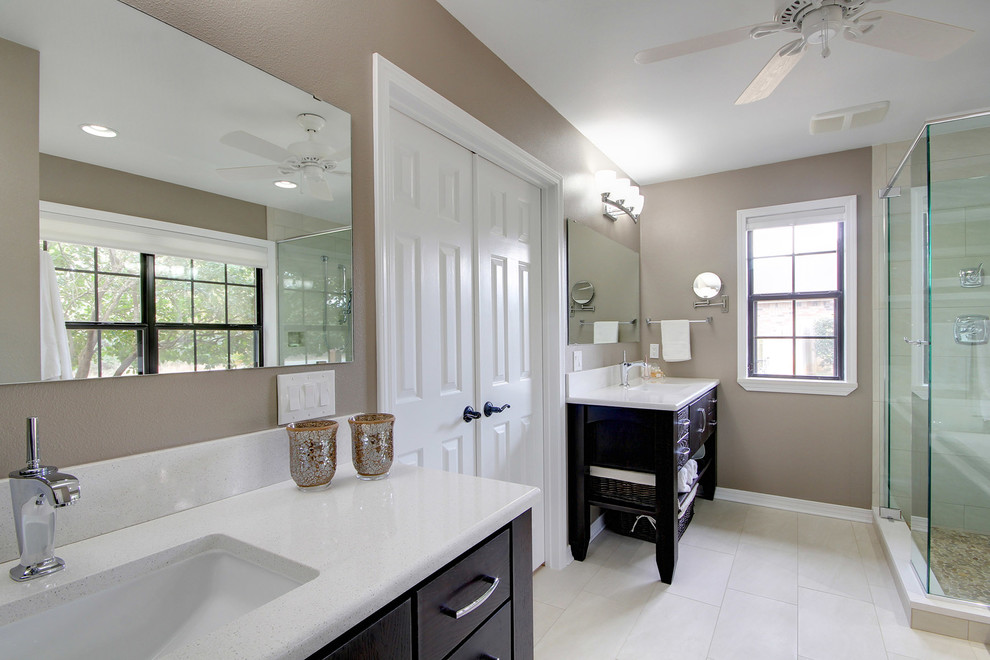 Photo of a traditional bathroom in Miami with dark wood cabinets.