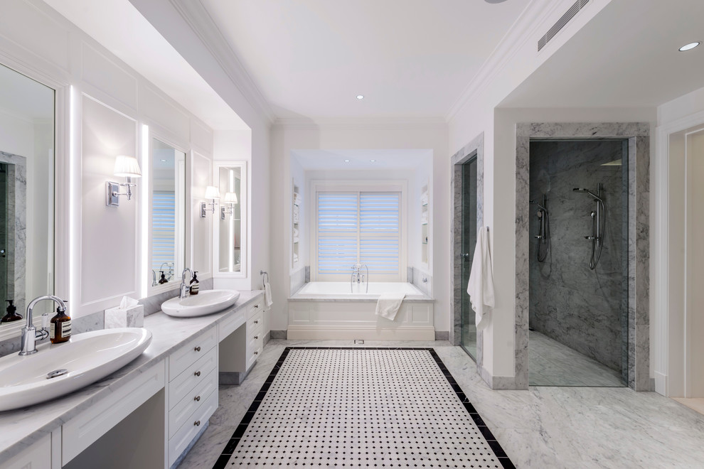 На фото: ванная комната в стиле неоклассика (современная классика) с фасадами в стиле шейкер, белыми фасадами, ванной в нише, угловым душем, белыми стенами и серой столешницей