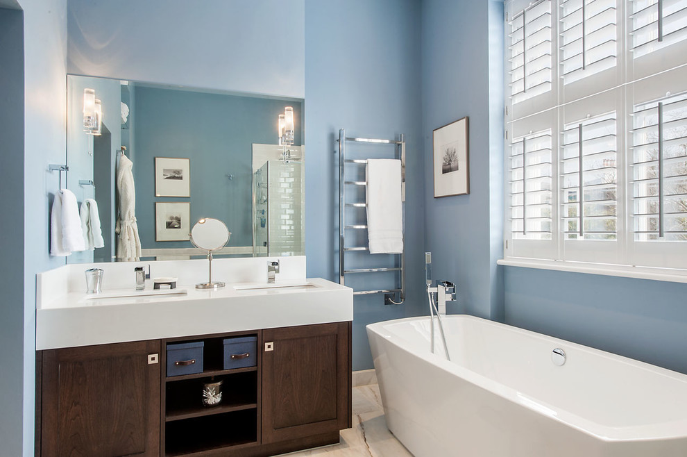 Medium sized classic ensuite bathroom in London with shaker cabinets, dark wood cabinets, a freestanding bath, blue walls, marble flooring, marble worktops and a submerged sink.