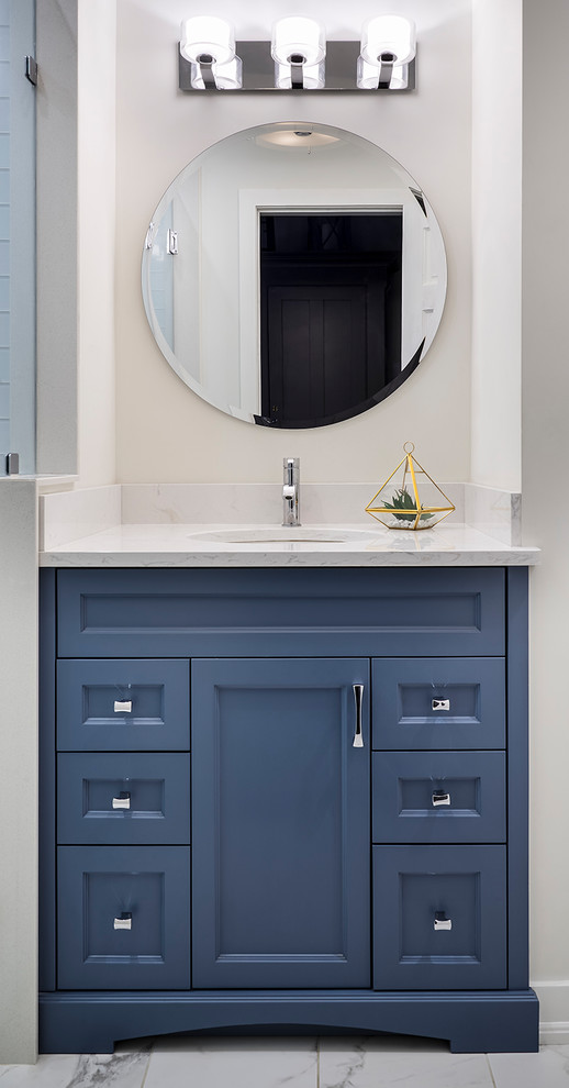 Doorless shower - small transitional kids' white tile and porcelain tile porcelain tile and white floor doorless shower idea in Toronto with furniture-like cabinets, blue cabinets, a one-piece toilet, white walls, an undermount sink, quartz countertops and a hinged shower door