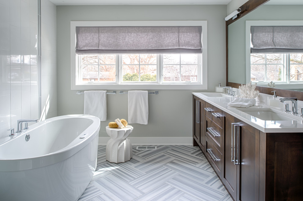 Mid-sized transitional freestanding bathtub photo in Minneapolis with shaker cabinets, dark wood cabinets and gray walls