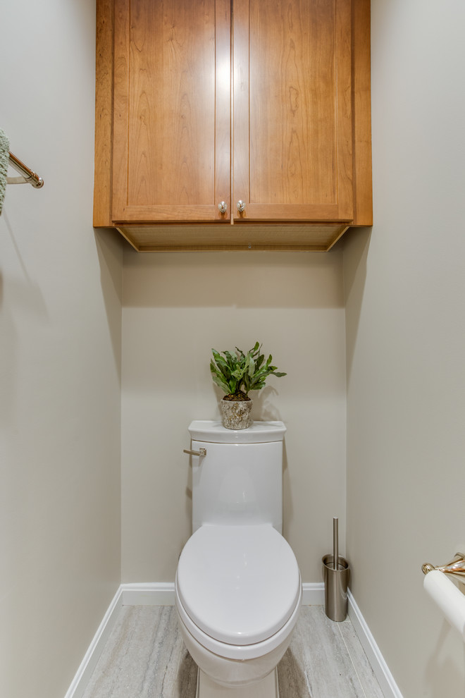 Example of a mid-sized transitional powder room design in DC Metro with shaker cabinets and quartz countertops