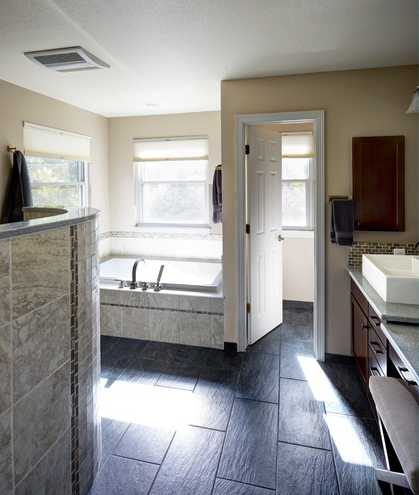 Example of a large transitional master beige tile, brown tile and porcelain tile ceramic tile bathroom design in Denver with dark wood cabinets, beige walls, a vessel sink, quartz countertops, flat-panel cabinets and a one-piece toilet