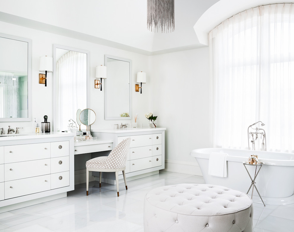 Classic bathroom in Toronto with a submerged sink, flat-panel cabinets, white cabinets, a freestanding bath and white walls.