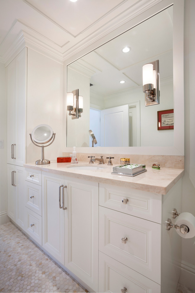 Example of a mid-sized transitional 3/4 beige floor bathroom design in Miami with recessed-panel cabinets, white cabinets, an undermount sink, beige walls and beige countertops