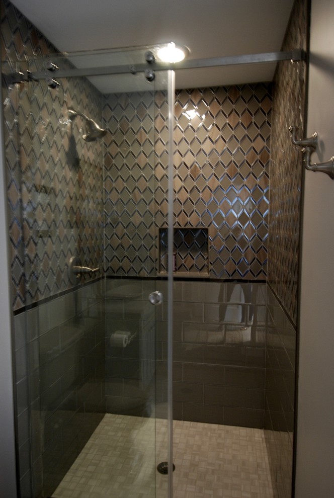 Photo of a medium sized rustic shower room bathroom in Miami with shaker cabinets, distressed cabinets, an alcove shower, a two-piece toilet, grey tiles, glass tiles, grey walls, porcelain flooring, a vessel sink, engineered stone worktops, grey floors and a sliding door.