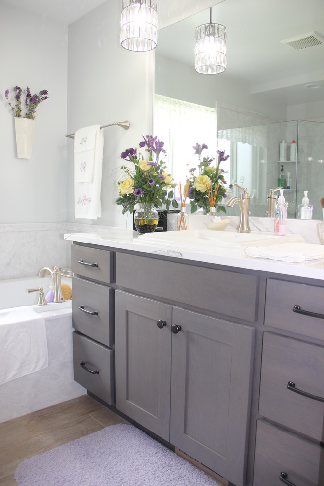 Imagen de cuarto de baño tradicional renovado pequeño con armarios estilo shaker, puertas de armario grises, paredes grises, aseo y ducha, lavabo encastrado y encimera de cuarzo compacto
