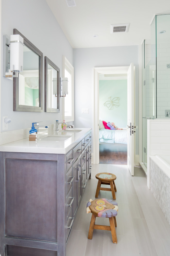 Inspiration for a mid-sized transitional kids' gray tile and porcelain tile porcelain tile bathroom remodel in Toronto with an undermount sink, shaker cabinets, gray cabinets, quartz countertops, a one-piece toilet and gray walls