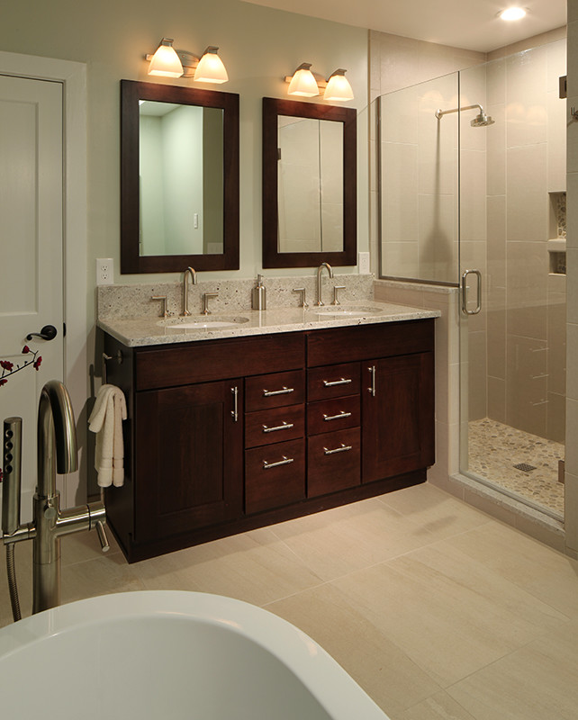 Example of a mid-sized transitional master beige tile and porcelain tile porcelain tile bathroom design in Denver with an undermount sink, shaker cabinets, dark wood cabinets, granite countertops, a two-piece toilet and green walls