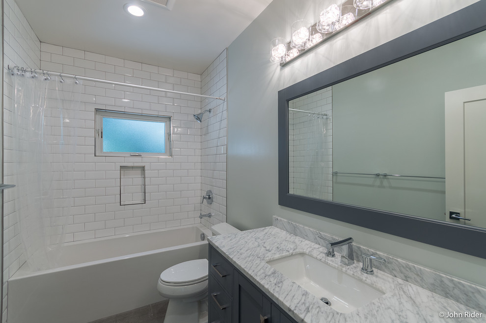 Inspiration for a medium sized classic family bathroom in San Francisco with shaker cabinets, grey cabinets, a freestanding bath, a shower/bath combination, a two-piece toilet, white tiles, ceramic tiles, grey walls, porcelain flooring, a submerged sink, marble worktops, grey floors and a shower curtain.
