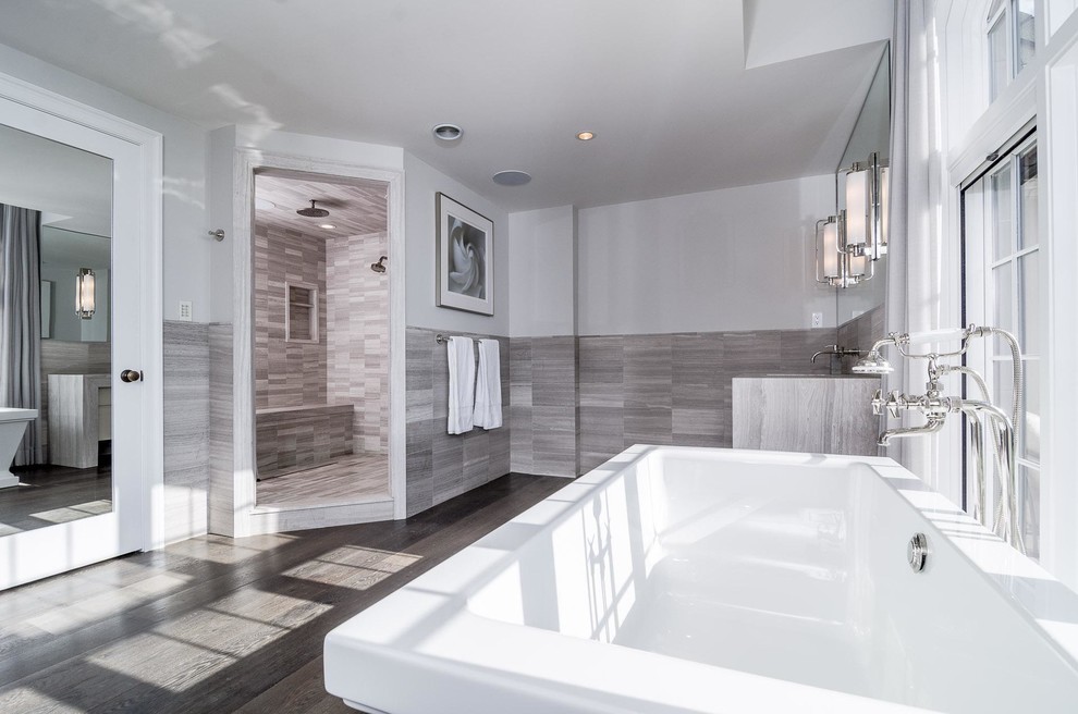 Large transitional master gray tile dark wood floor and brown floor bathroom photo in San Francisco with flat-panel cabinets, beige cabinets, gray walls, an integrated sink, granite countertops, a hinged shower door and beige countertops