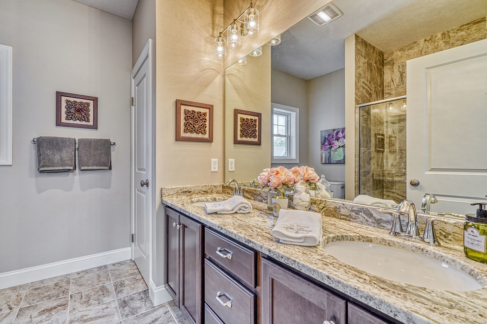 Inspiration for a huge transitional master multicolored tile and ceramic tile ceramic tile and multicolored floor bathroom remodel in New York with raised-panel cabinets, dark wood cabinets, a one-piece toilet, gray walls, an undermount sink, granite countertops and multicolored countertops