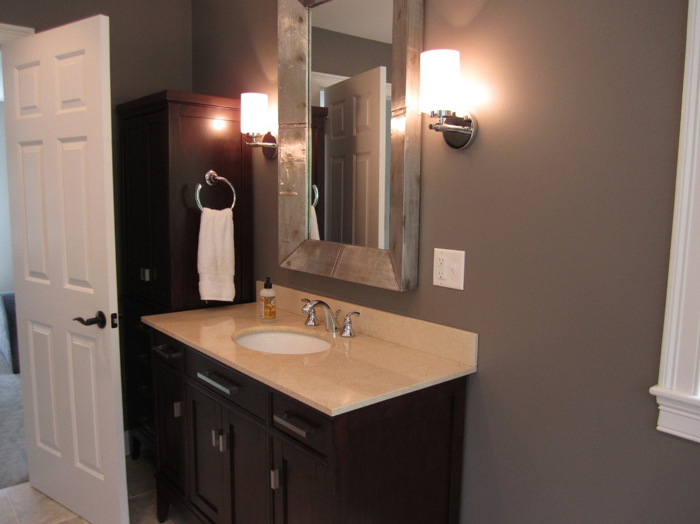 Large transitional master beige tile and porcelain tile porcelain tile bathroom photo in Boston with an undermount sink, recessed-panel cabinets, dark wood cabinets, marble countertops and gray walls