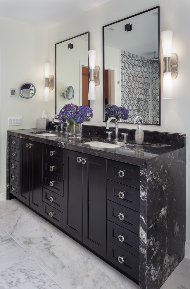 Photo of a traditional bathroom in DC Metro with recessed-panel cabinets, black cabinets, beige walls, a submerged sink, white floors and black worktops.
