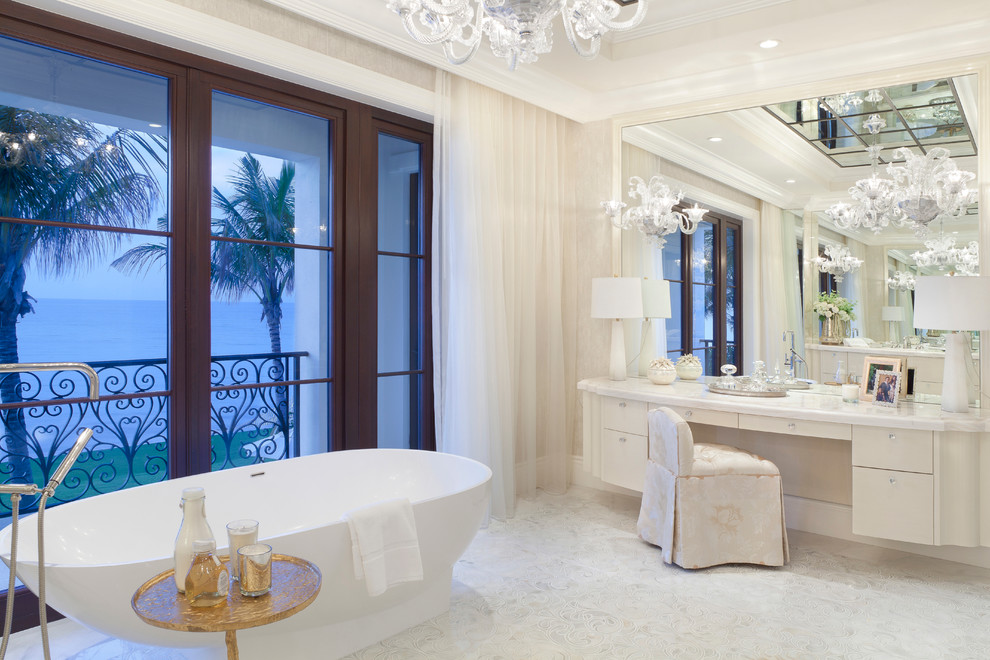 Foto di una stanza da bagno padronale tradizionale con ante lisce, ante beige, top in marmo, vasca freestanding e pavimento in marmo