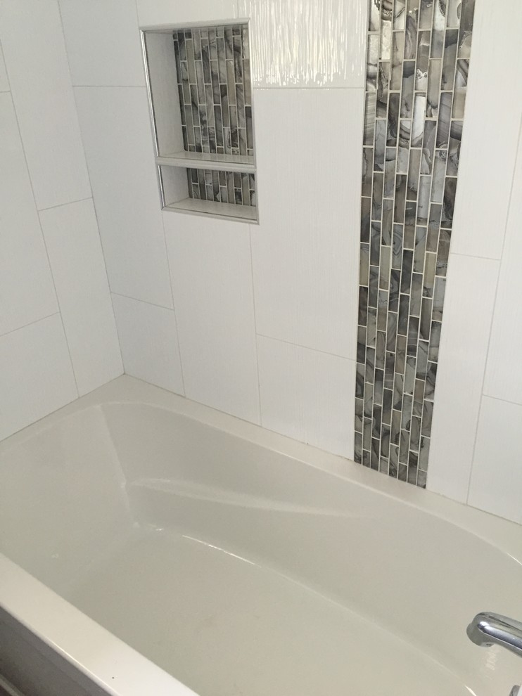 Design ideas for a classic bathroom in Calgary with an alcove bath, a shower/bath combination, multi-coloured tiles, white tiles, porcelain tiles and white walls.