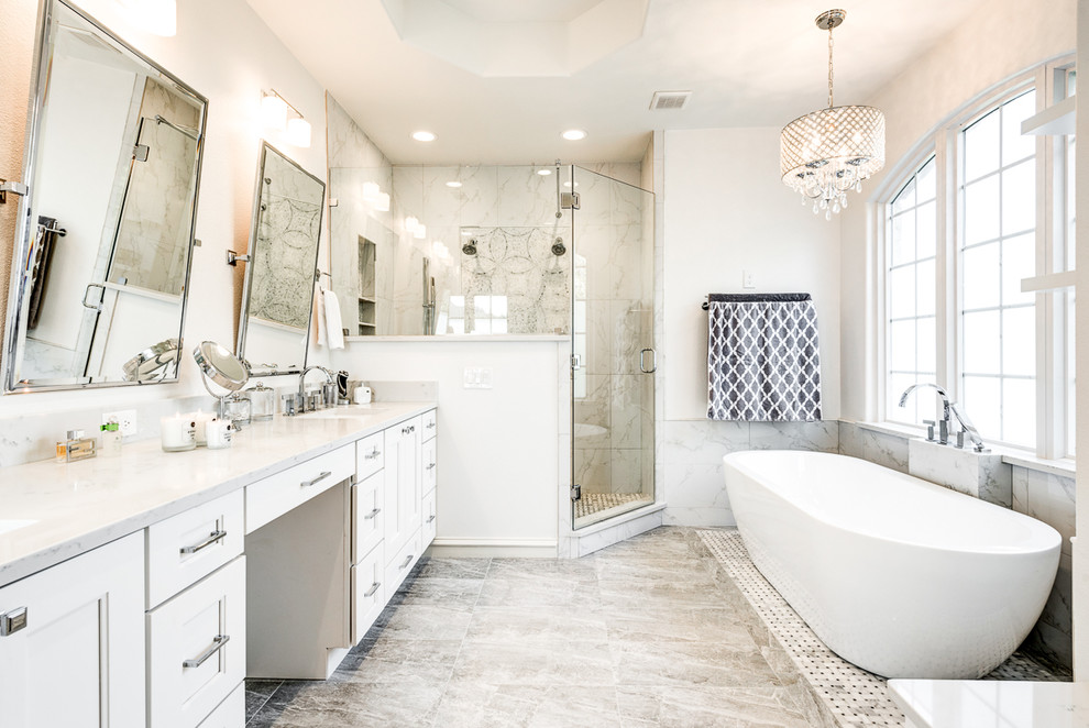 This is an example of a large traditional ensuite bathroom in Dallas with white cabinets, a hot tub, porcelain flooring, grey floors, a hinged door, beaded cabinets, an alcove shower, white tiles, marble tiles, grey walls, a submerged sink, marble worktops and white worktops.