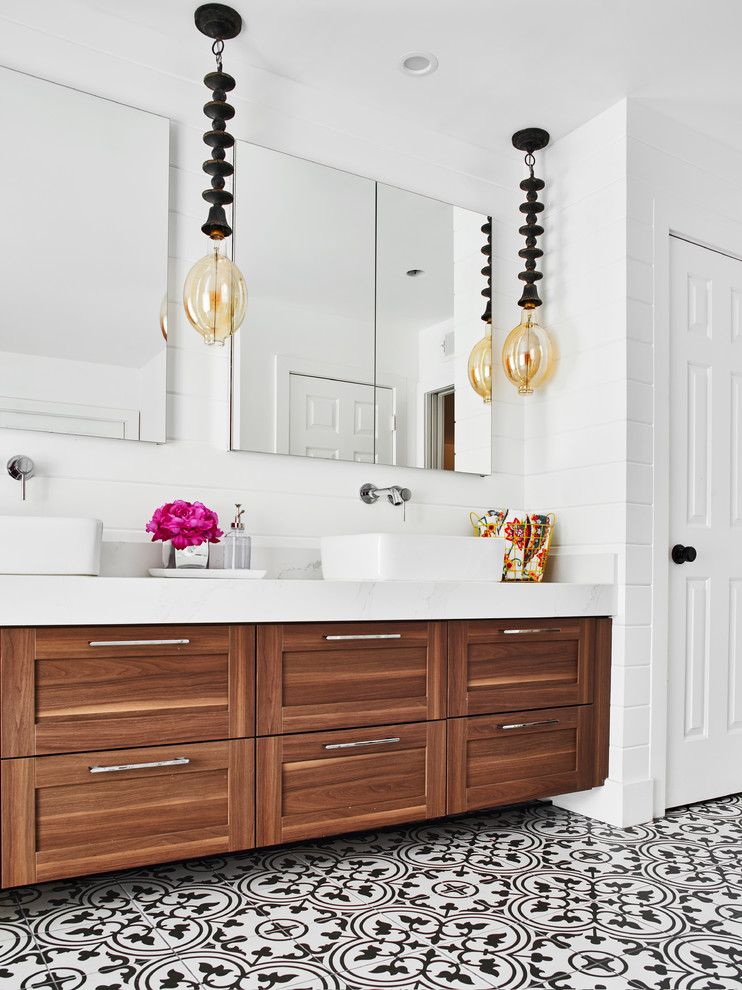 Inspiration for a medium sized classic bathroom in Phoenix with recessed-panel cabinets, brown cabinets, a walk-in shower, white walls, cement flooring, a vessel sink, engineered stone worktops, white floors, an open shower and white worktops.