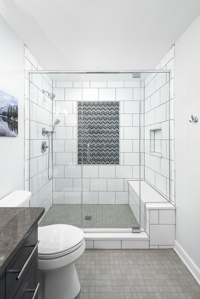 Example of a mid-sized transitional kids' white tile and ceramic tile gray floor and ceramic tile alcove shower design in Chicago with gray walls, multicolored countertops, flat-panel cabinets, black cabinets, a two-piece toilet, an undermount sink, limestone countertops and a hinged shower door
