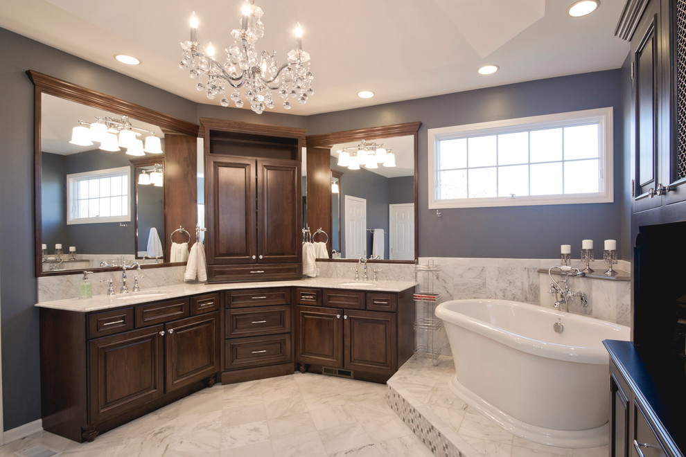 Mid-sized elegant master white tile and stone tile marble floor bathroom photo in Chicago with raised-panel cabinets, dark wood cabinets, a two-piece toilet, gray walls, an undermount sink and marble countertops