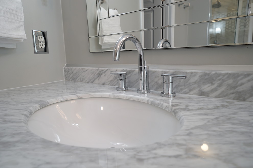 Mid-sized transitional master white tile and porcelain tile porcelain tile and white floor bathroom photo in Atlanta with furniture-like cabinets, dark wood cabinets, a one-piece toilet, gray walls, an undermount sink, marble countertops and a hinged shower door