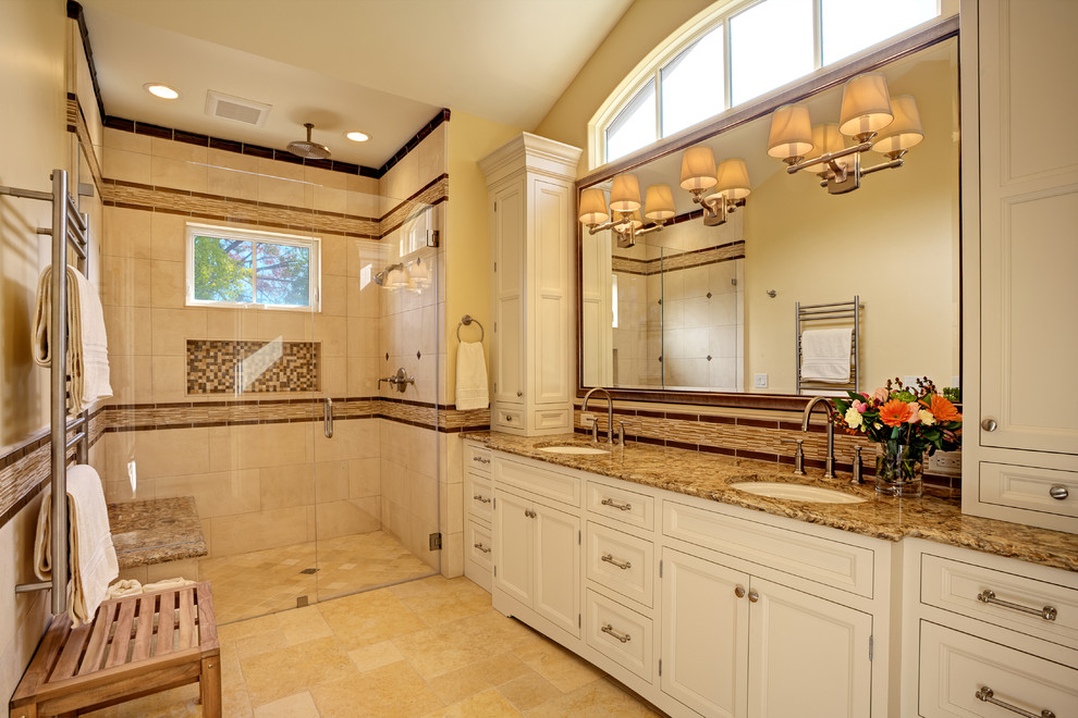 Inspiration for a large transitional master beige tile and stone tile limestone floor walk-in shower remodel in San Francisco with an undermount sink, beaded inset cabinets, white cabinets, quartz countertops, a one-piece toilet and beige walls
