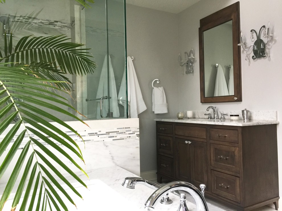 Large traditional ensuite bathroom in Chicago with shaker cabinets, medium wood cabinets, a submerged bath, a corner shower, a one-piece toilet, white tiles, mosaic tiles, grey walls, marble flooring, a submerged sink and marble worktops.