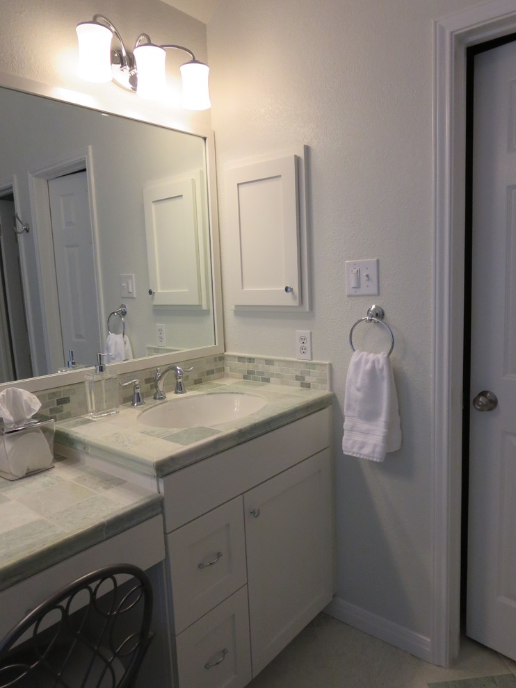 Medium sized traditional ensuite bathroom in Austin with shaker cabinets, white cabinets, a built-in bath, a corner shower, a one-piece toilet, green tiles, marble tiles, green walls, marble flooring, a submerged sink, marble worktops, green floors and a hinged door.