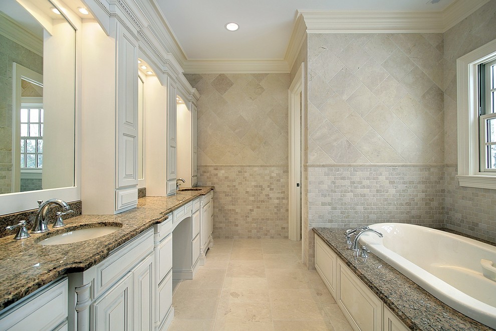 Photo of a large classic ensuite bathroom in Atlanta with a submerged sink, raised-panel cabinets, grey cabinets, granite worktops, a built-in bath, a corner shower, a two-piece toilet, multi-coloured tiles, stone tiles, multi-coloured walls and limestone flooring.