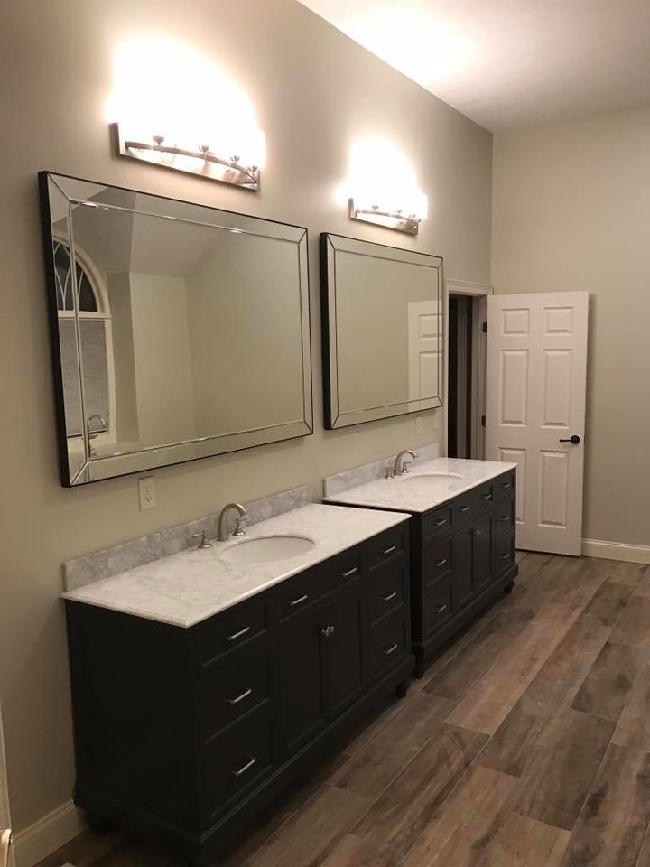 Photo of a large traditional ensuite bathroom in Cleveland with shaker cabinets, black cabinets, a freestanding bath, a corner shower, white tiles, marble tiles, grey walls, dark hardwood flooring, a submerged sink, marble worktops and brown floors.