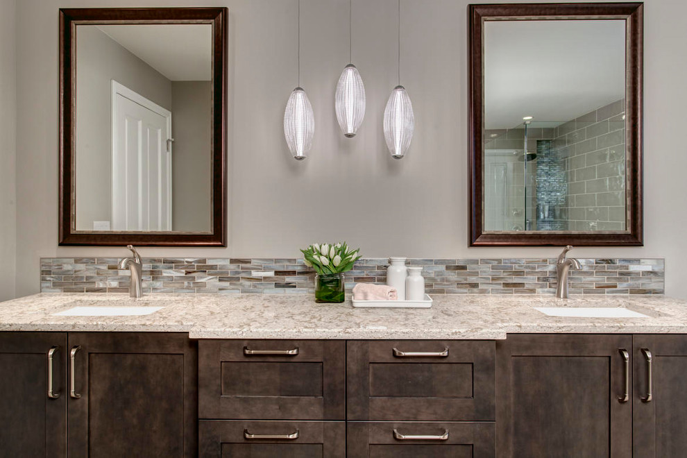 Example of a large transitional master multicolored tile and matchstick tile pebble tile floor bathroom design in Seattle with shaker cabinets, dark wood cabinets, a two-piece toilet, beige walls, an undermount sink and quartz countertops