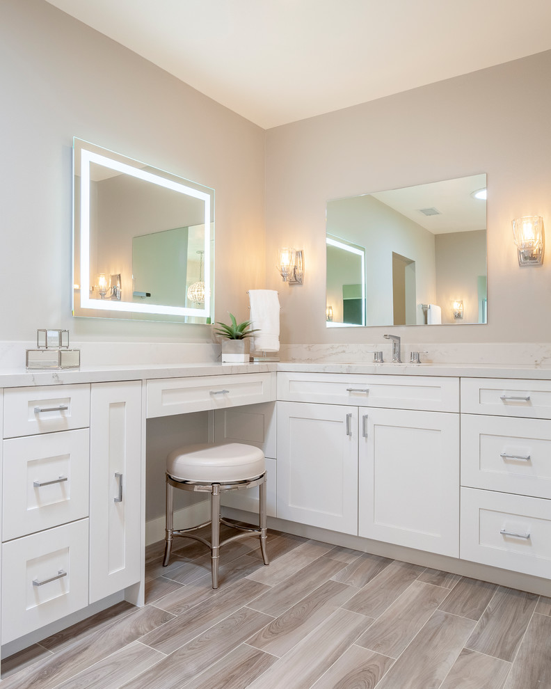 This is an example of a large classic ensuite bathroom in Los Angeles with shaker cabinets, white cabinets, grey walls, porcelain flooring, a submerged sink, engineered stone worktops and white worktops.