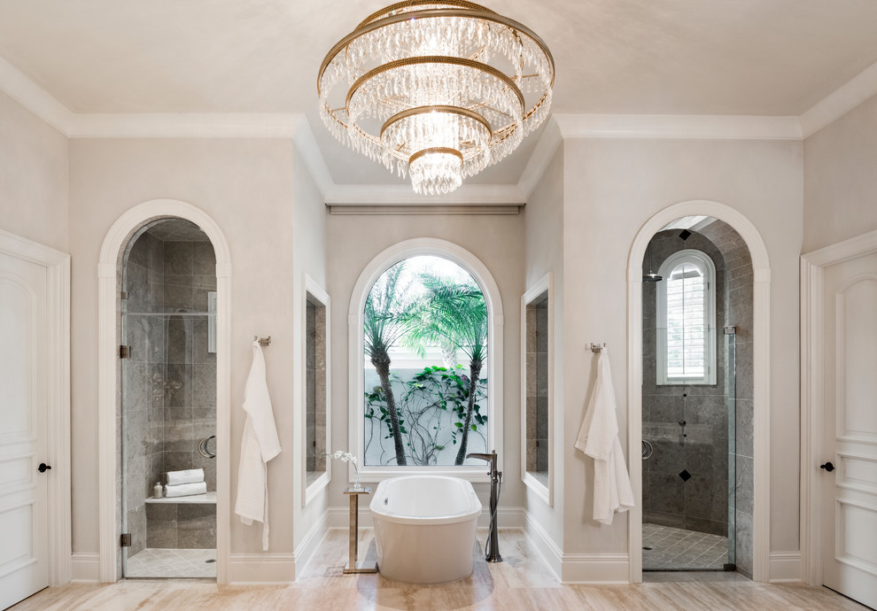 Foto di una stanza da bagno padronale tradizionale con vasca freestanding, zona vasca/doccia separata, piastrelle grigie, pareti beige, pavimento beige e porta doccia a battente