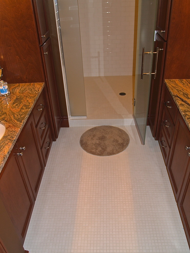 Example of a mid-sized transitional master white tile and mosaic tile mosaic tile floor alcove shower design in Milwaukee with recessed-panel cabinets, medium tone wood cabinets, marble countertops and brown walls