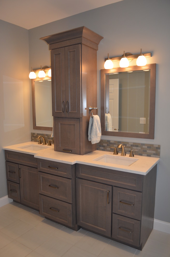 Example of a mid-sized transitional master brown tile, gray tile and matchstick tile porcelain tile and beige floor bathroom design in Boston with an undermount sink, recessed-panel cabinets, quartz countertops, medium tone wood cabinets, gray walls and a one-piece toilet