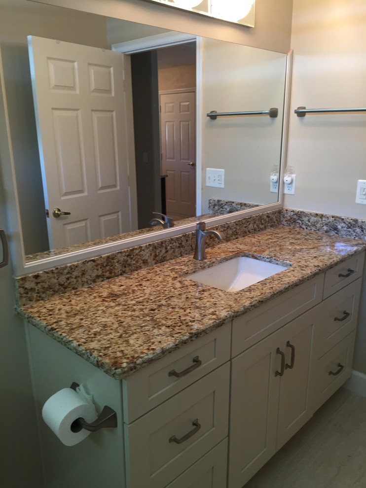 Mid-sized transitional 3/4 bathroom photo in Orlando with flat-panel cabinets, white cabinets, beige walls, an undermount sink and granite countertops
