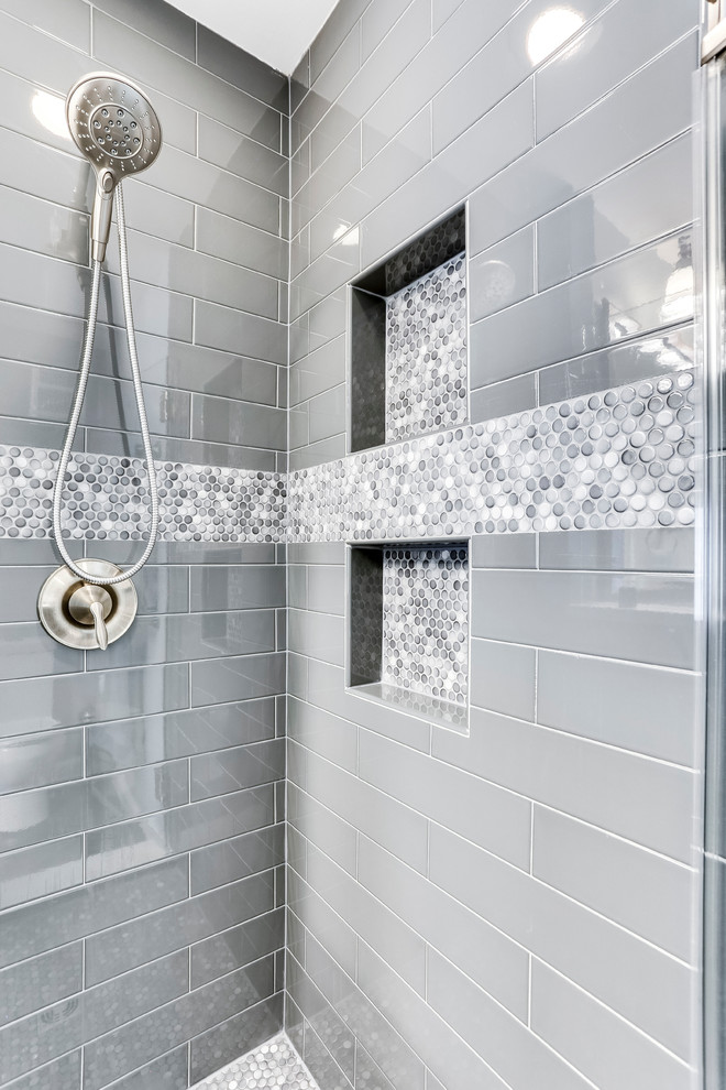Example of a small transitional master ceramic tile bathroom design in DC Metro with raised-panel cabinets, an undermount sink, quartz countertops and a hinged shower door