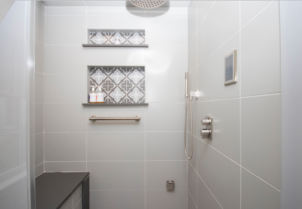 Inspiration for a large traditional ensuite bathroom in Boston with recessed-panel cabinets, white cabinets, a corner shower, a two-piece toilet, grey tiles, ceramic tiles, grey walls, ceramic flooring, a submerged sink, engineered stone worktops, grey floors, a hinged door and grey worktops.